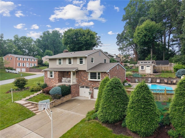 511 Brunswick Dr, Hempfield Twp, PA 15601 - view of front of home with brick siding, an attached garage, driveway, and a chimney