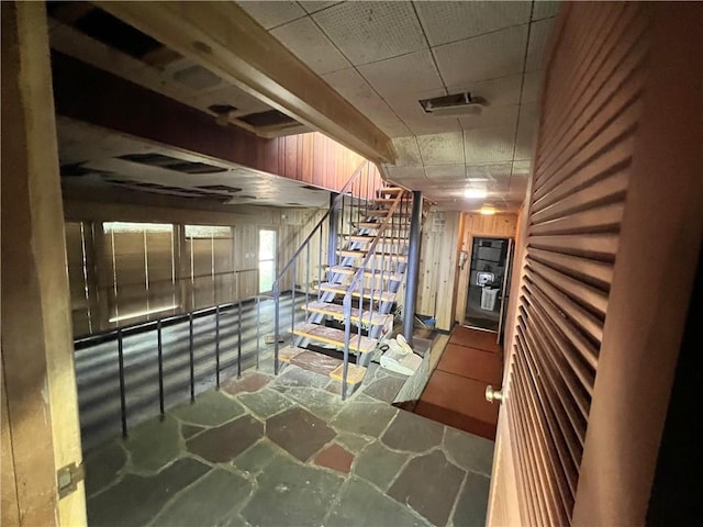 1560 Oneida Dr, Jefferson Hills, PA 15025 - stairway featuring a drop ceiling, stone flooring, and wooden walls