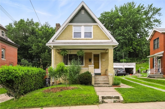 4329 Stanton Ave, Stanton Heights, PA 15201 - view of front of house with a porch, a front lawn, a chimney, and brick siding