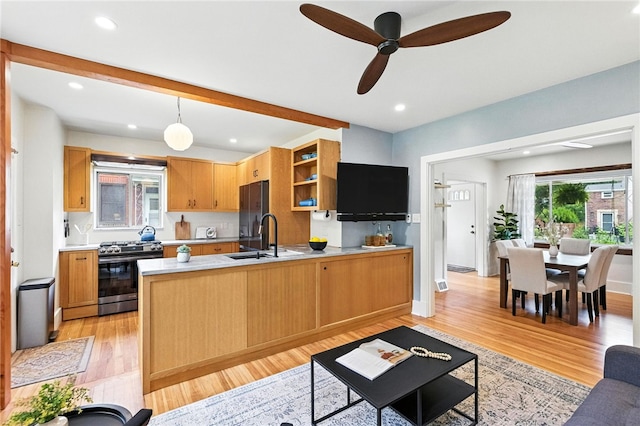 4329 Stanton Ave, Stanton Heights, PA 15201 - kitchen with stainless steel range with gas cooktop, light countertops, a peninsula, light wood-style flooring, and a ceiling fan