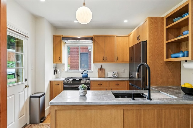 4329 Stanton Ave, Stanton Heights, PA 15201 - kitchen featuring stainless steel gas range oven, a peninsula, hanging light fixtures, recessed lighting, and light wood-style flooring