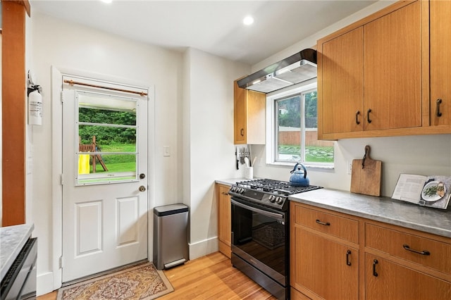 4329 Stanton Ave, Stanton Heights, PA 15201 - kitchen featuring stainless steel range with gas stovetop, light wood-style floors, recessed lighting, wall chimney range hood, and brown cabinetry