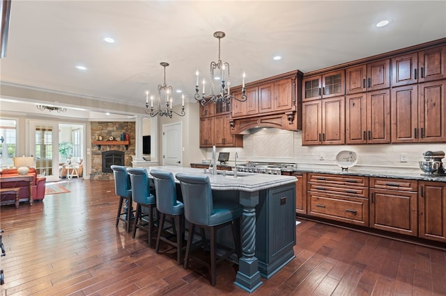 3111 Edelweiss Ct Ste 201, Adams Twp, PA 16046 - kitchen featuring a kitchen bar, open floor plan, dark wood finished floors, glass insert cabinets, and recessed lighting