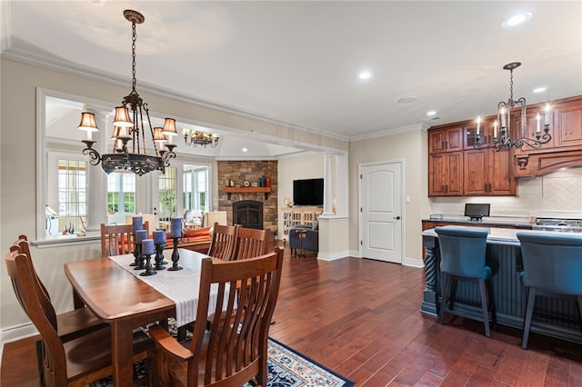 3111 Edelweiss Ct Ste 201, Adams Twp, PA 16046 - dining room featuring a chandelier, ornamental molding, dark wood finished floors, recessed lighting, and a stone fireplace