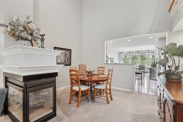 774 Norwegian Spruce Dr, Adams Twp, PA 16046 - carpeted dining space with a multi sided fireplace, a towering ceiling, and recessed lighting