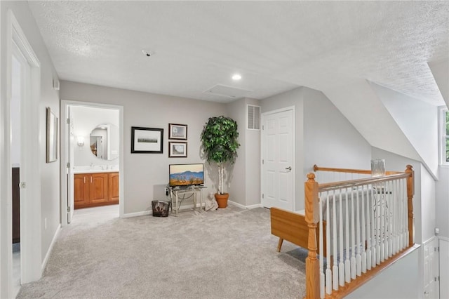 774 Norwegian Spruce Dr, Adams Twp, PA 16046 - sitting room featuring light carpet, a textured ceiling, and an upstairs landing