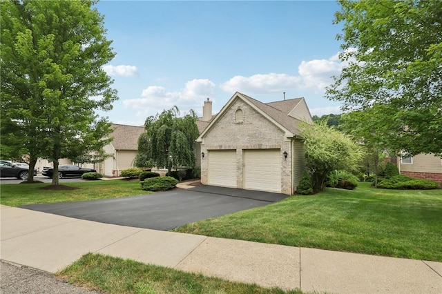774 Norwegian Spruce Dr, Adams Twp, PA 16046 - view of front of home featuring brick siding, a front yard, asphalt driveway, a chimney, and a garage