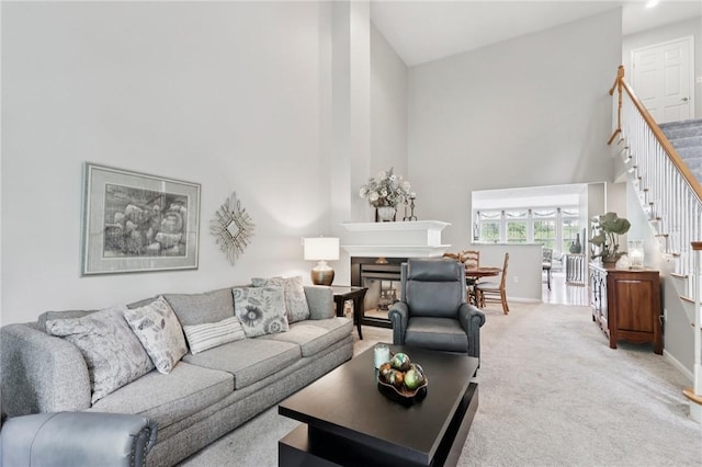 774 Norwegian Spruce Dr, Adams Twp, PA 16046 - living area with high vaulted ceiling, stairs, a fireplace, and light carpet