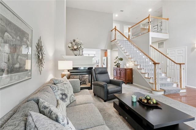 774 Norwegian Spruce Dr, Adams Twp, PA 16046 - living area featuring stairs, a towering ceiling, recessed lighting, and a glass covered fireplace