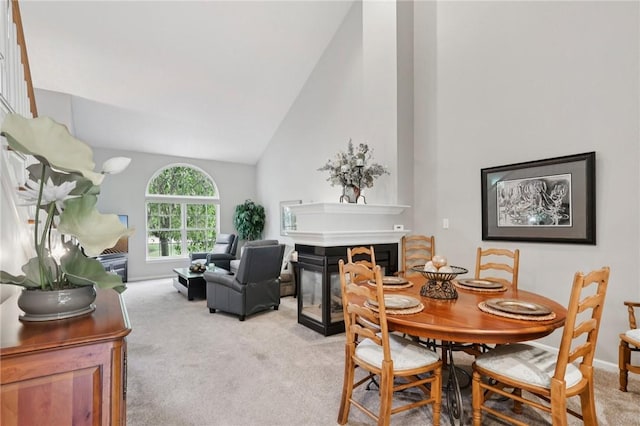 774 Norwegian Spruce Dr, Adams Twp, PA 16046 - dining room with light carpet, a glass covered fireplace, and high vaulted ceiling