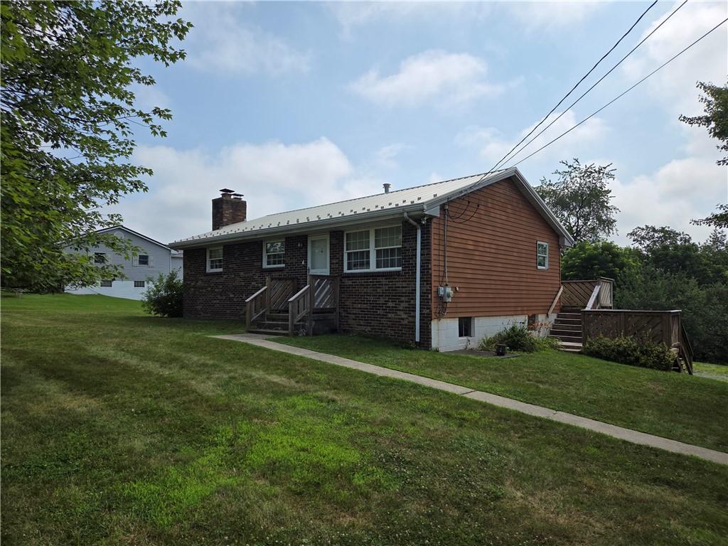 317 Highview Cir, New Sewickley Twp, PA 15042 - rear view of property with a chimney, a yard, a metal roof, and stairway