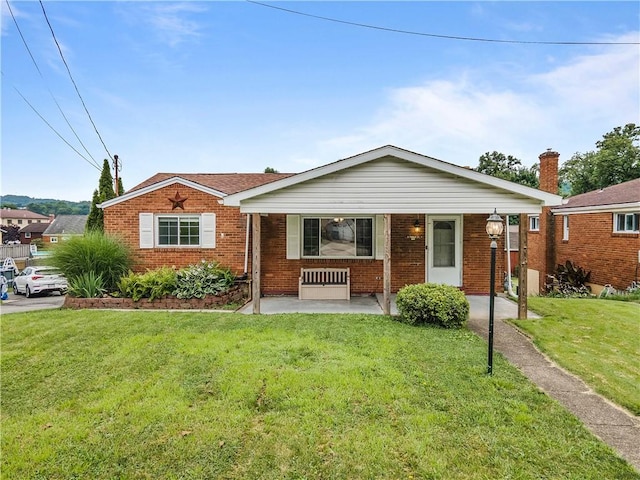 10 Ronald St, West Elizabeth, PA 15088 - view of front of house featuring brick siding, covered porch, and a front lawn