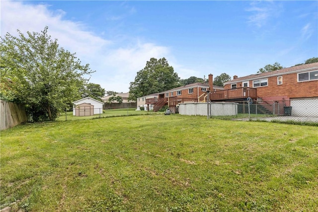 10 Ronald St, West Elizabeth, PA 15088 - fenced backyard featuring a deck, a storage unit, and stairs