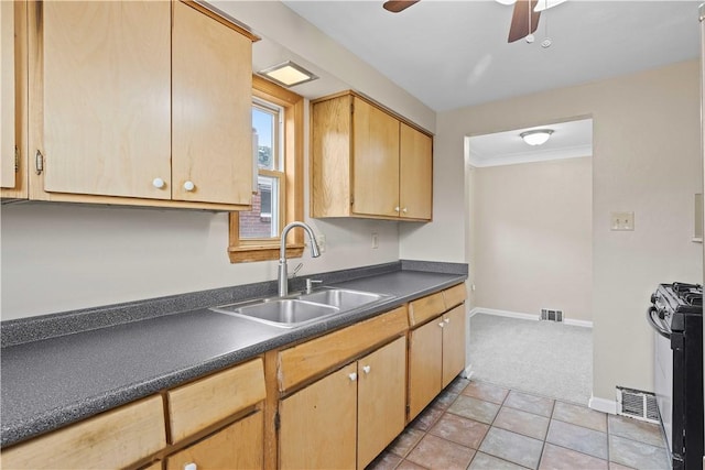 10 Ronald St, West Elizabeth, PA 15088 - kitchen featuring gas range, light colored carpet, dark countertops, ceiling fan, and light tile patterned floors