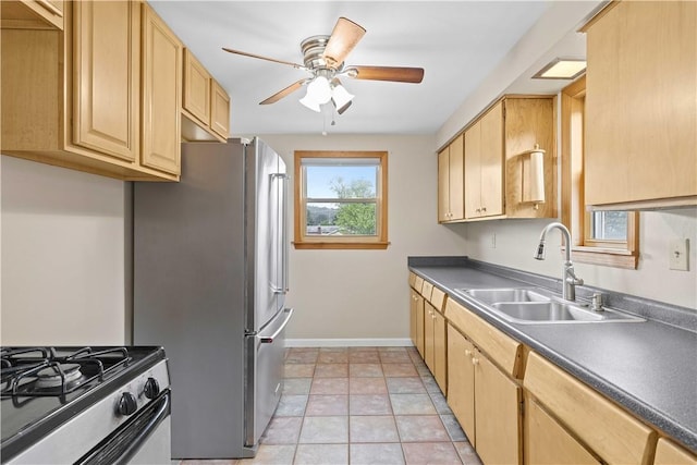 10 Ronald St, West Elizabeth, PA 15088 - kitchen with ceiling fan, dark countertops, light brown cabinetry, and appliances with stainless steel finishes