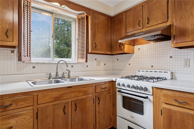 1920 Cheryl Dr, North Huntingdon, PA 15642 - kitchen featuring white gas range oven, under cabinet range hood, light countertops, tasteful backsplash, and brown cabinetry