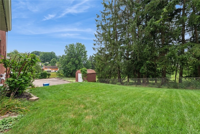 1920 Cheryl Dr, North Huntingdon, PA 15642 - view of yard with a shed, a patio area, and view of wooded area