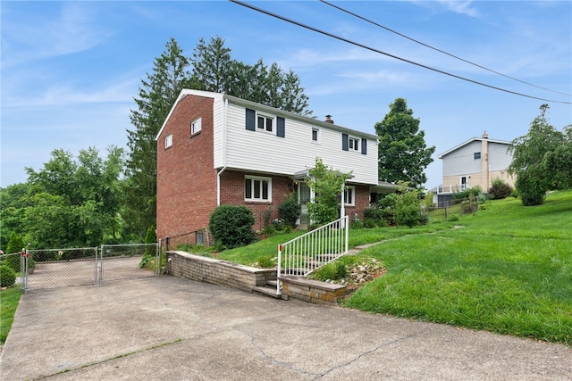 1920 Cheryl Dr, North Huntingdon, PA 15642 - colonial home with brick siding, a gate, a chimney, and driveway