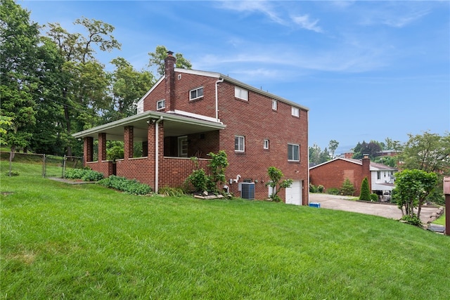 1920 Cheryl Dr, North Huntingdon, PA 15642 - view of side of property featuring a chimney, driveway, an attached garage, and brick siding