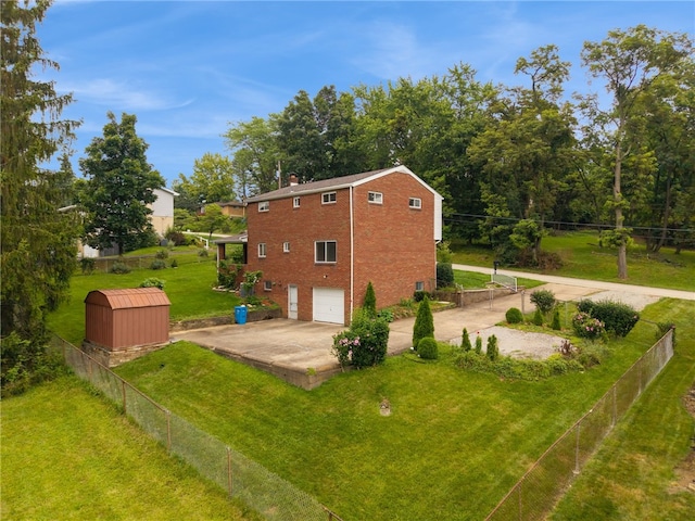 1920 Cheryl Dr, North Huntingdon, PA 15642 - view of property exterior featuring a garage, driveway, brick siding, a shed, and a chimney