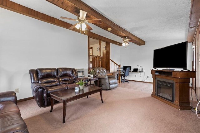 3914 38th St, Pulaski Twp, PA 15066 - living room with a ceiling fan, beamed ceiling, carpet, a glass covered fireplace, and stairway
