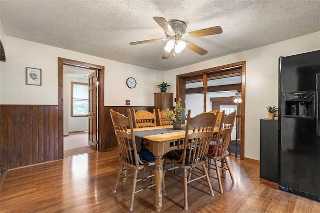 3914 38th St, Pulaski Twp, PA 15066 - dining space with wood finished floors, a wainscoted wall, ceiling fan, wooden walls, and a textured ceiling