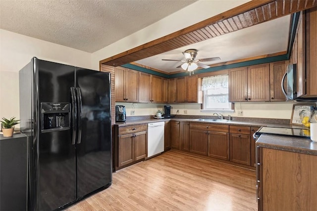 3914 38th St, Pulaski Twp, PA 15066 - kitchen featuring black fridge with ice dispenser, dishwasher, stainless steel microwave, light wood-type flooring, and a textured ceiling