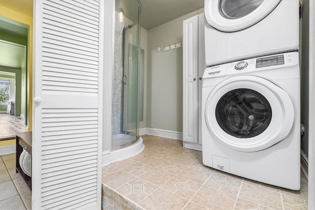 115 Nursery Rd, Forward Twp, PA 16053 - washroom featuring stacked washer / dryer and light tile patterned flooring