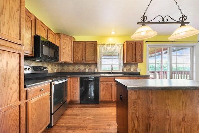 538 Bluegrass Dr, Canonsburg, PA 15317 - kitchen with black appliances, dark countertops, light wood finished floors, backsplash, and pendant lighting