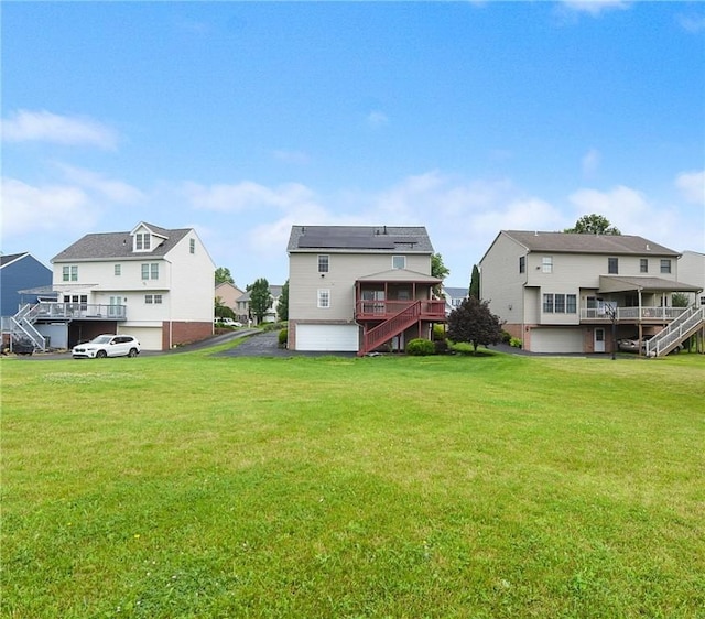 538 Bluegrass Dr, Canonsburg, PA 15317 - rear view of house featuring stairs, a residential view, a lawn, and a wooden deck