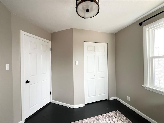 1069 Martin Ave, New Kensington, PA 15068 - unfurnished bedroom featuring a closet and dark wood finished floors
