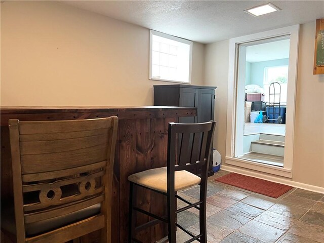 1069 Martin Ave, New Kensington, PA 15068 - office area with stone tile flooring, a textured ceiling, and a dry bar