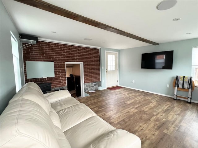 1069 Martin Ave, New Kensington, PA 15068 - living area featuring wood finished floors, beam ceiling, and brick wall
