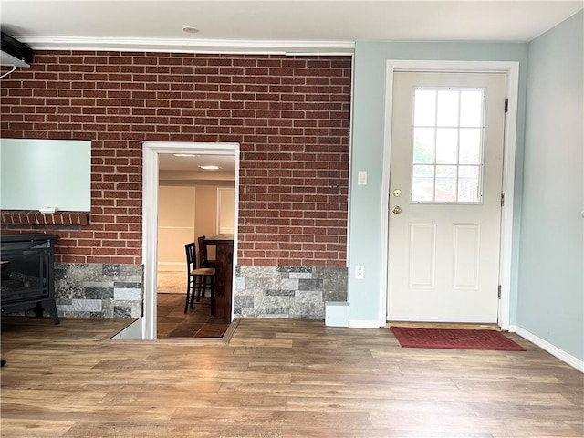 1069 Martin Ave, New Kensington, PA 15068 - unfurnished living room with wood finished floors, a wood stove, and ornamental molding