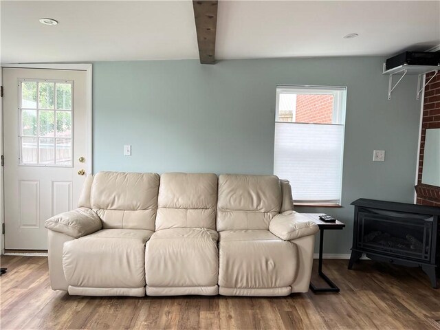 1069 Martin Ave, New Kensington, PA 15068 - living room featuring wood finished floors, beam ceiling, and a wood stove