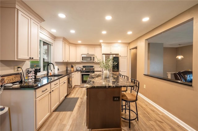 43 Dover Rd, Penn Twp, PA 15642 - kitchen with stainless steel appliances, light wood-type flooring, a kitchen breakfast bar, recessed lighting, and a kitchen island