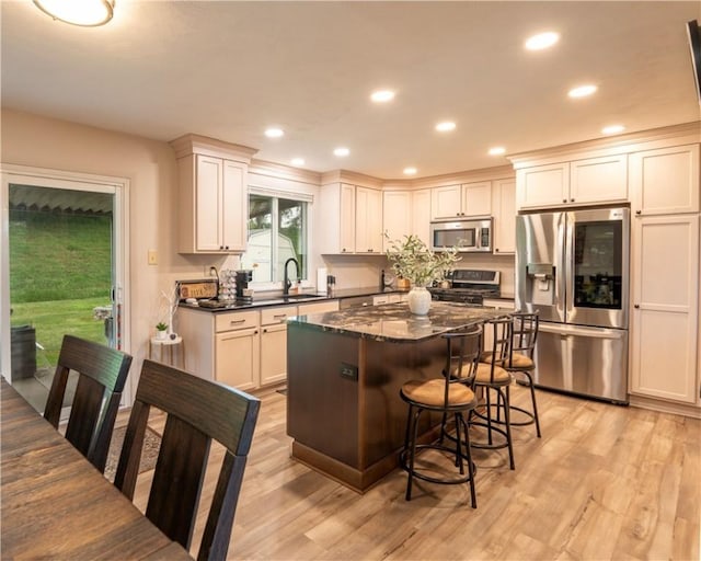 43 Dover Rd, Penn Twp, PA 15642 - kitchen with stainless steel appliances, a kitchen bar, a kitchen island, light wood-style floors, and recessed lighting