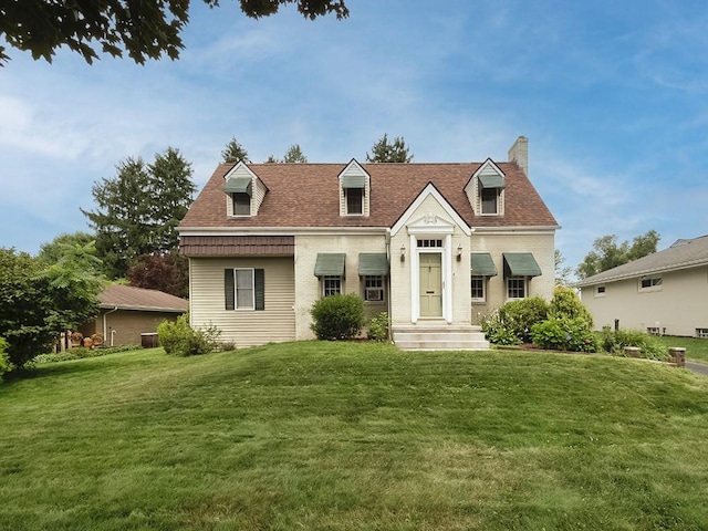 881 Ridge Rd, Harmony Twp, PA 15003 - cape cod-style house with a front yard, a chimney, and brick siding