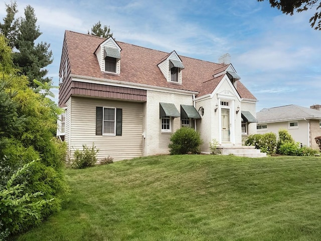 881 Ridge Rd, Harmony Twp, PA 15003 - view of front of home featuring a front yard, brick siding, roof with shingles, and a chimney