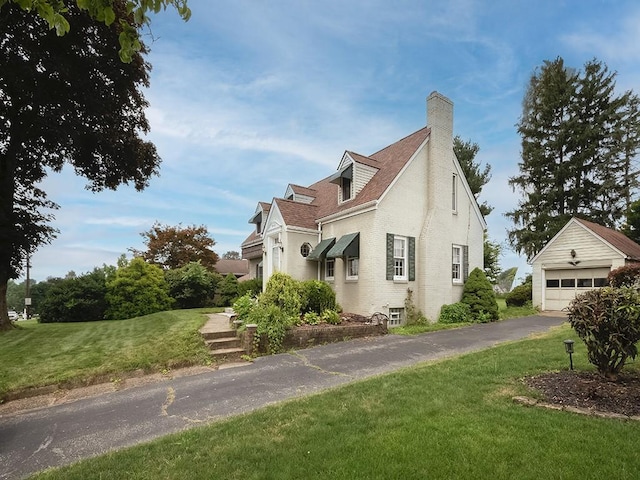 881 Ridge Rd, Harmony Twp, PA 15003 - view of side of home with a chimney, a yard, an outdoor structure, brick siding, and a garage