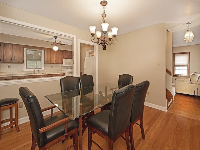 881 Ridge Rd, Harmony Twp, PA 15003 - dining space featuring light wood-style flooring, a chandelier, a ceiling fan, and a baseboard heating unit