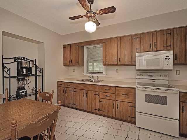 881 Ridge Rd, Harmony Twp, PA 15003 - kitchen featuring white appliances, brown cabinetry, and light countertops