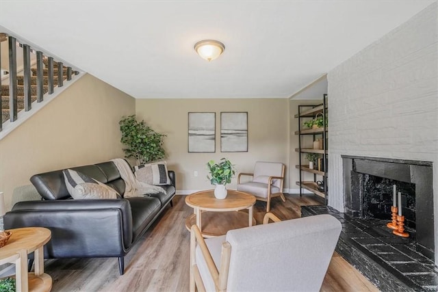 7321 Ringertown Rd, Murrysville, PA 15632 - living area with wood finished floors, a warm lit fireplace, and stairs