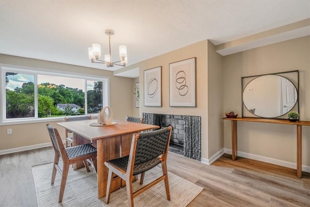 7321 Ringertown Rd, Murrysville, PA 15632 - dining room with a chandelier, light wood finished floors, and a fireplace