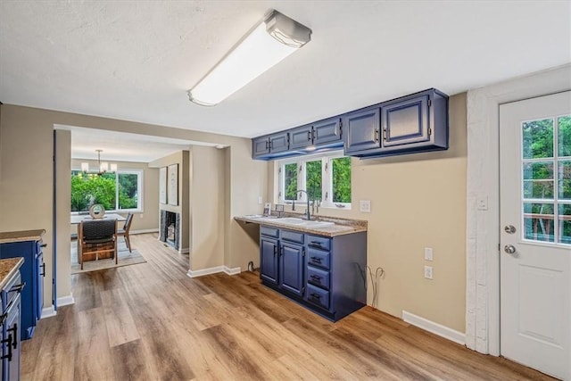 7321 Ringertown Rd, Murrysville, PA 15632 - kitchen featuring blue cabinetry, light wood finished floors, and healthy amount of natural light