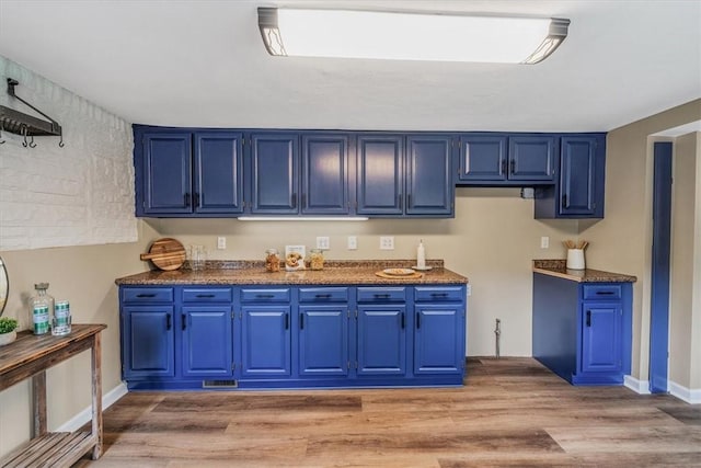 7321 Ringertown Rd, Murrysville, PA 15632 - kitchen with blue cabinetry, light wood-style flooring, and dark countertops