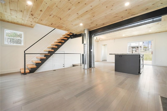 233 E 21st Ave, Munhall, PA 15120 - unfurnished living room featuring healthy amount of natural light, wooden ceiling, wood finished floors, stairway, and recessed lighting