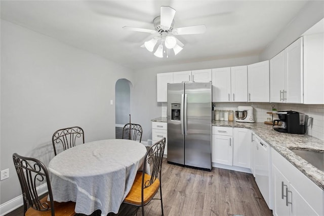 516 Shenango Rd, Chippewa Twp, PA 15010 - kitchen with stainless steel refrigerator with ice dispenser, arched walkways, a ceiling fan, and white cabinets