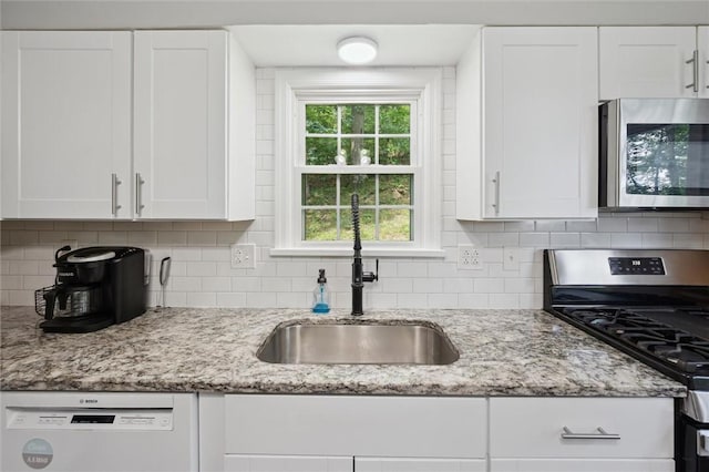 516 Shenango Rd, Chippewa Twp, PA 15010 - kitchen with appliances with stainless steel finishes, white cabinets, light stone countertops, and tasteful backsplash