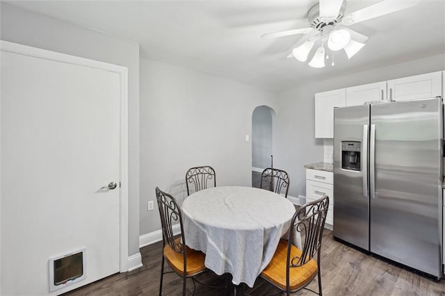 516 Shenango Rd, Chippewa Twp, PA 15010 - dining room with arched walkways, ceiling fan, and wood finished floors